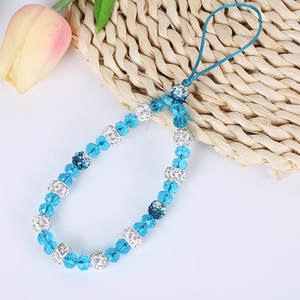 Detail of blue crystal bead phone strap with rhinestone accents and flower pendant charm