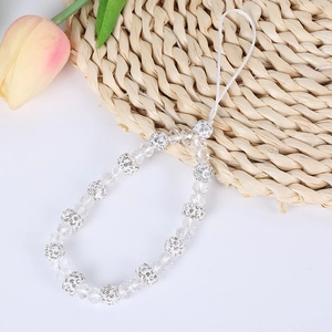 Detail of beaded phone strap with clear crystals, diamond balls and flower pendant