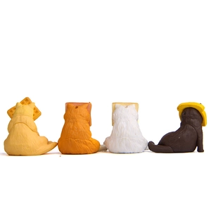 Rear view of four cute Japanese style cat figurines with toast and waffle headwear