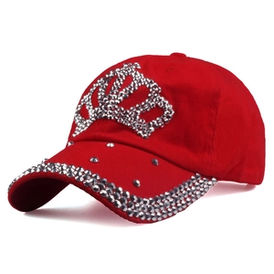Red baseball cap with rhinestone crown and metal rivets on the brim, minimalist white background