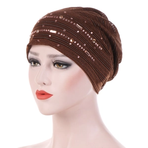 Detail of breathable lace cap with sparkling pink rhinestones and metallic knit texture