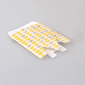 Detailed view of foldable white paper gift box with yellow tulip floral pattern print