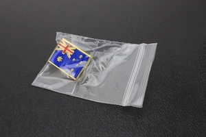 Macro shot of Australian flag enamel lapel pin in gold plated finish for backpacks