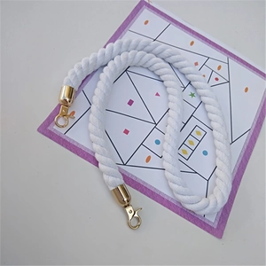 Close-up of white braided rope strap with premium gold metal clasps for shoulder bags