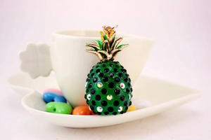 Macro detail of rhinestone-studded pineapple keychain with gold-tone leaf decoration