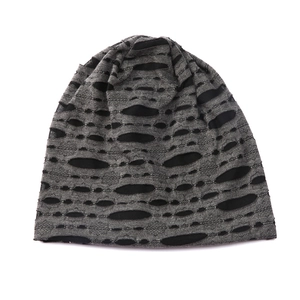 Detail of dark grey knit beanie featuring a distressed ripped design and breathable mesh lining