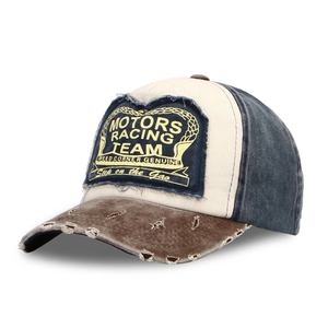 Detail of vintage washed denim racing cap with frayed edges and Motors Racing Team embroidery