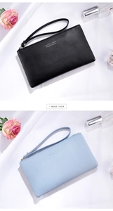 Detail of minimalist PU leather wristlet wallets in black and blue with metal zipper