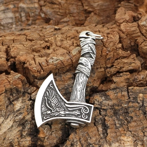 Silver Viking double axe necklace pendant with eagle engraving on textured bark background