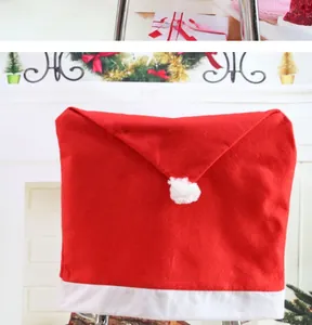 Detail of red Santa hat chair cover with white trim and plush ball for Christmas decor