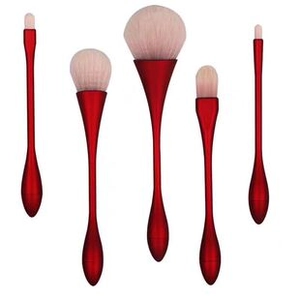 Close-up of 5 red metallic makeup brushes with soft cream bristles on white background