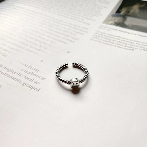 Detailed close-up of a vintage S925 silver smile face ring with a twisted rope band design