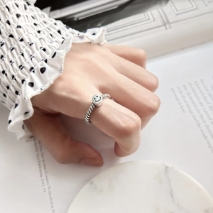 Close-up of a vintage S925 sterling silver smile ring with a twisted rope band design