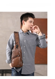 Detail of brown leather chest bag showing adjustable strap and smooth zipper compartments
