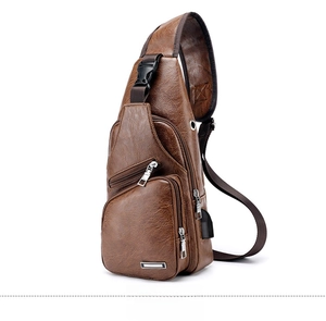 Detailed side view of brown leather sling bag with USB charging port and zipper pockets