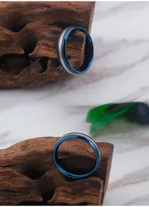 Macro detail of men's blue and silver titanium steel ring with brushed metal center stripe