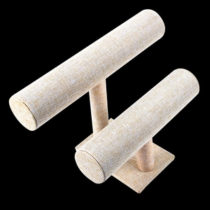 Dual-tier beige linen T-bar jewelry display stand for bracelets and watches on black background