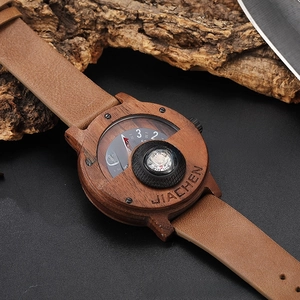 Macro shot of retro walnut wood watch with compass dial and brown leather strap