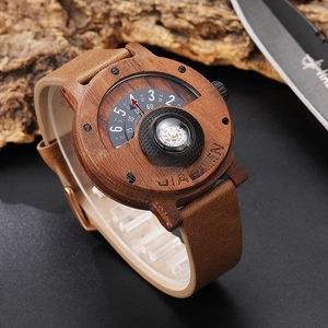 Close-up of wood watch case with built-in compass dial and brown leather strap on bark