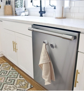 Silver round self-adhesive towel holders set on stainless steel kitchen cabinet