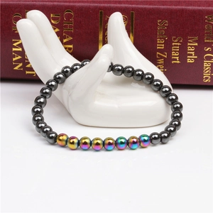 Detail of 6mm magnetic hematite beaded bracelet with colorful plated beads on ceramic hand