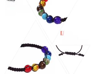 Close-up of adjustable chakra bracelet with seven colorful natural stones and black woven cord