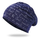 Close-up of navy blue knitted beanie with white script pattern and thick soft lining