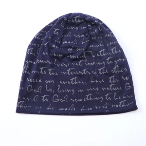 Detail of navy knit beanie featuring gray handwritten script print on soft cotton fabric