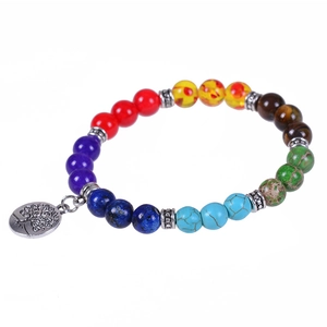 Chakra bracelet with natural stones and silver Tree of Life charm on white background