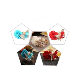Detailed close-up of bohemian butterfly and rose rings in five vibrant color variations