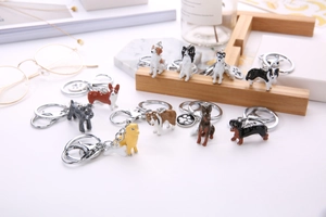 Detailed arrangement of 3D alloy dog keychains with corgi and husky on a desk