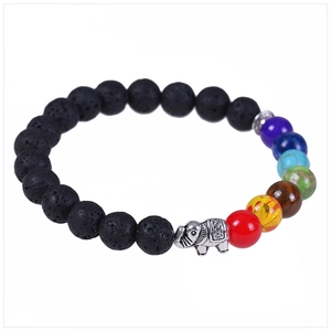 Macro detail of 8mm volcanic stone beads with seven chakra gems and silver elephant charm
