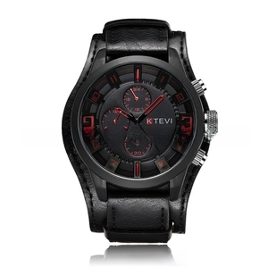 Close-up of a men's sport watch with a black dial and red numerals on a leather strap