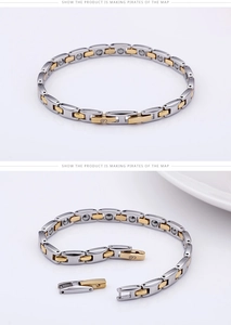 Detail view of magnetic titanium steel bracelet in silver and gold links with clasp