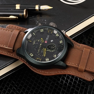 Macro shot of KTEVI black frosted chronograph watch with brown leather strap and date window