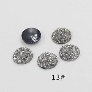 Macro detail of 12mm silver resin glitter druzy cabochons with flat black back for DIY