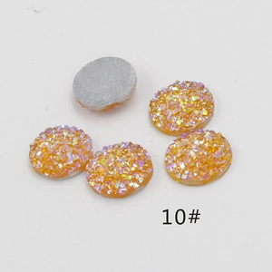 Detailed view of 12mm orange holographic resin rhinestones with flat silver backs for DIY