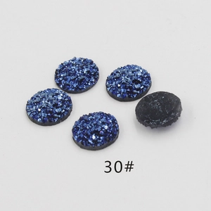 Macro view of 12mm deep blue resin druzy cabochons with sparkling crystalline texture
