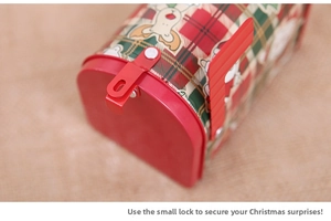 Close-up of a festive Christmas tin mailbox showing the lock mechanism and plaid design