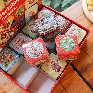 Christmas square tin box set with embossed Santa and reindeer patterns on wooden table