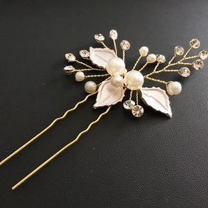 Elegant bridal hair pin with white leaves, faux pearls, and rhinestones on gold wire