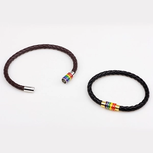 Close-up of black and brown braided leather bracelets with rainbow magnetic clasps