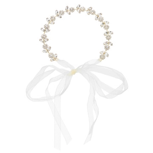 Detailed view of rhinestone leaf patterns and white ribbons on a gold bridal headpiece