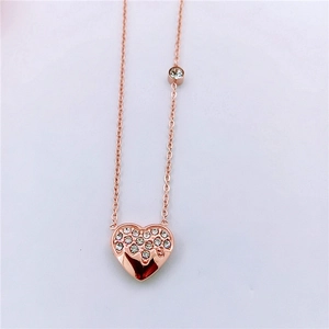 Detail view of rose gold heart pendant with sparkling rhinestones and fine chain link