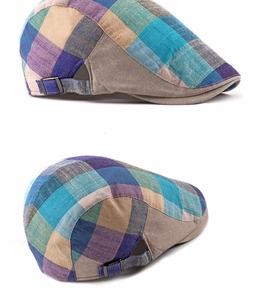 Detail of plaid newsboy cap with checkered pattern and adjustable metal buckle back
