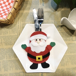 Santa Claus themed cutlery holder for Christmas table setting with festive dinnerware
