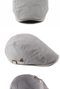 Detailed view of grey linen beret featuring striped lining and copper metal buckle