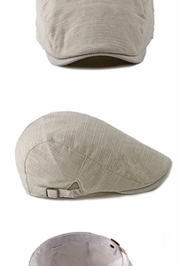 Detail view of khaki cotton flat cap featuring metal adjustment buckle and striped texture