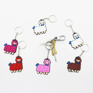 Detail of colorful PVC alpaca keychains with silver metal rings in various vibrant colors