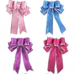 Detail of glittered 25cm Christmas bows in pink, blue, purple, and rose red colors